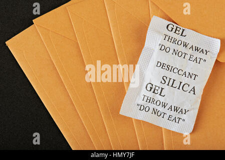 silica gel package lay on yellow envelop Stock Photo