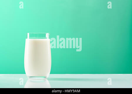 full milk glass on green background isolated Stock Photo