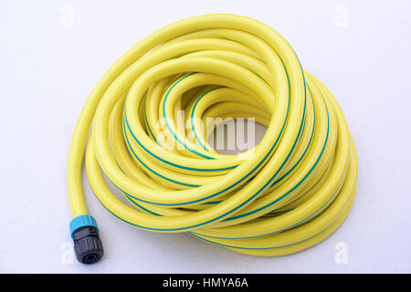 Garden hose-pipe whit coupling on a white background Stock Photo