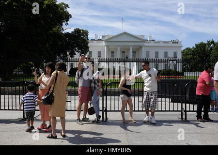 Tourists take selfies in front of The White House. Stock Photo