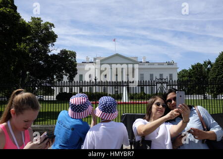 Tourists take selfies in front of The White House. Stock Photo