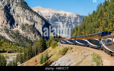 The Rocky Mountaineer railway train winds it's way through Banff National Park in Alberta, Canada.