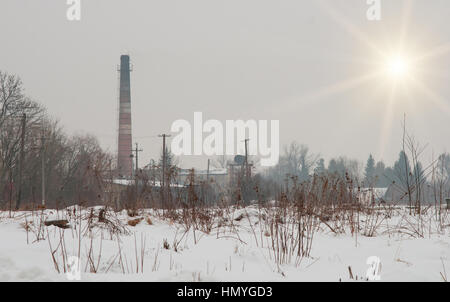 brick factory chimney. Tube for propulsion bricks in the furnace. Pipe on a background sunset Stock Photo