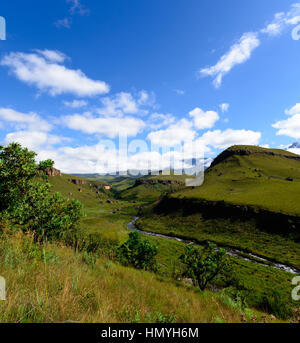 Drakensberg Giants Castle (South Africa) green mountains scenic view with blue sky and a creek Stock Photo