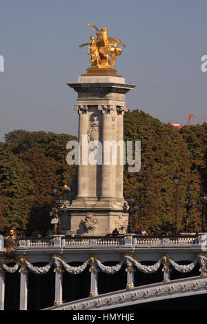 One of the four gilt-bronze statues of Fames watch over the Pont Alexandre III, over River Seine, Paris, France Stock Photo
