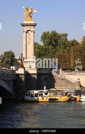 One of the four gilt-bronze statues of Fames watch over the Pont Alexandre III. Stock Photo