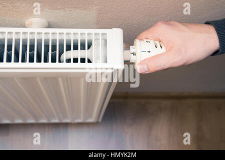 hand on heater Stock Photo