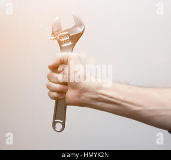 adjustable wrench in worker hand Stock Photo