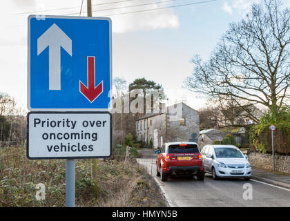 Car driver ignoring road sign giving priority over oncoming vehicles , Brough, Derbyshire. England, UK Stock Photo