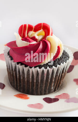 M&S Chocolate raspberry & prosecco cupcakes - single cake on heart plate - ideal for valentines day, valentine day Stock Photo