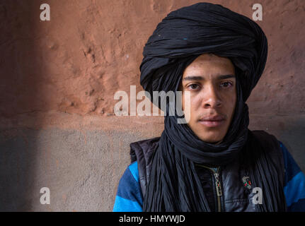 Morocco.  Teenage Amazigh Berber Young Man in Turban, Ait Benhaddou Ksar, a World Heritage Site. Stock Photo