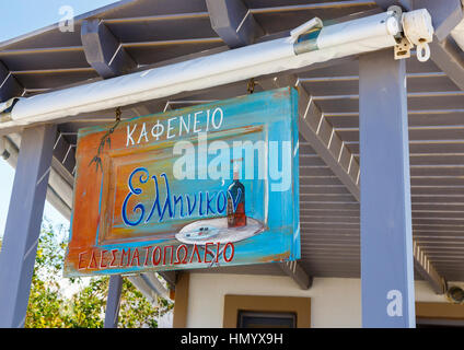 Typical tasteful rustic colourful painted taverna sign at a café restaurant at Oia, Santorini, a Mediterranean Greek Island in the Cyclades group Stock Photo