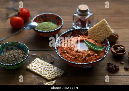 Walnuts and pepper dip sauce Muhammara and ingredients close-up on the table. horizontal Stock Photo