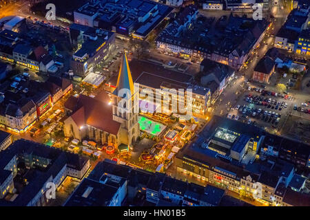 Christmas market with ice rink at St. Paul's church at night, Hamm, Ruhr district, North Rhine-Westphalia, Germany Stock Photo