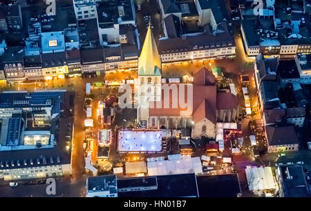 Christmas market with ice rink at St. Paul's church at night, Hamm, Ruhr district, North Rhine-Westphalia, Germany Stock Photo