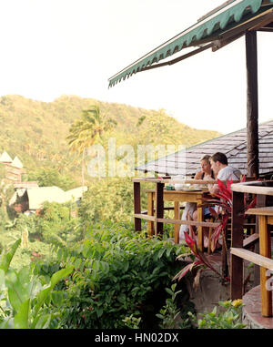 An young couple enjoys breakfast at Dasheene Restaurant  at Ladera Resort. Ladera is considered on of the best resorts in the Caribbean. Soufriere, St Stock Photo