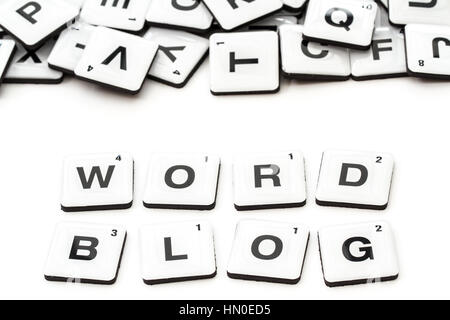 The word Blog created from alphabet shaped squares or scrabble tiles on an isolated white background for a social media blogger or internet blogging. Stock Photo