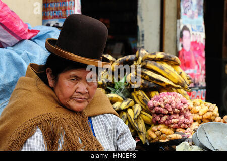 LA PAZ, BOLIVIA - OCTOBER 26: woman in the ethnic dress is selling a vegetable of the capital city of Bolivia of the city La Paz in South America Stock Photo