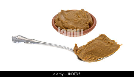 A spoonful of cookie butter in the foreground with a bowl filled in the background. Stock Photo