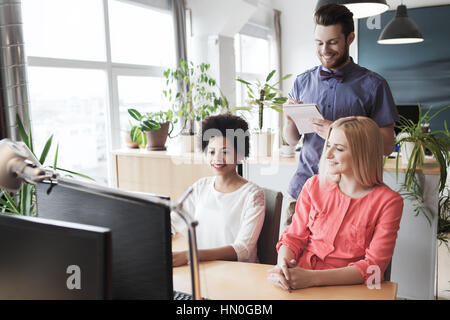 happy creative team with computer in office Stock Photo