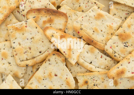 A very close view of broken pizza crust chips. Stock Photo