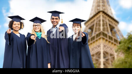 happy bachelors pointing at you over eiffel tower Stock Photo