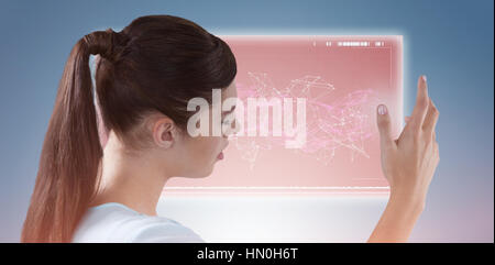 Young woman using imaginative digital screen against purple vignette Stock Photo