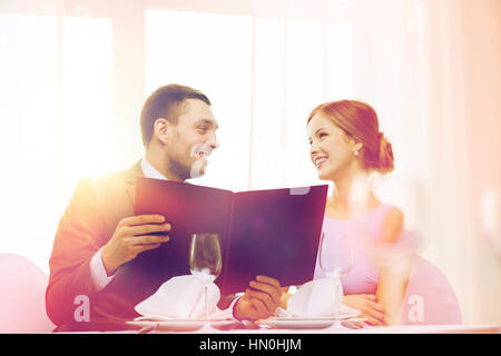 smiling couple with menu at restaurant Stock Photo