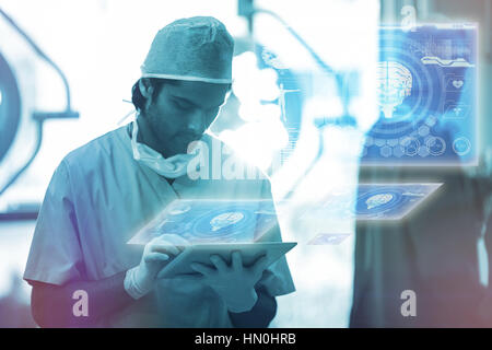 Medical biology interface in blue against surgeon using digital tablet in operation room 3d Stock Photo
