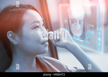 Digitally generated image of human skull against thoughtful nurse in hospital 3d Stock Photo