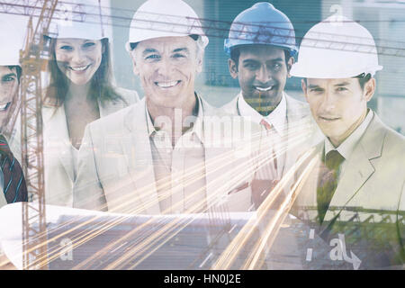 Crane and building construction site  against portrait of architects wearing hardhats Stock Photo