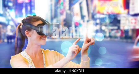 Woman using a virtual reality device against blurry new york street Stock Photo