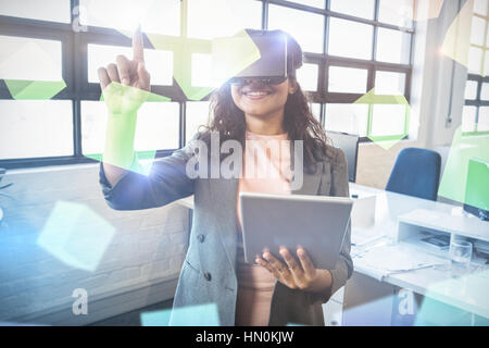 Digitally generated grey cubes floating  against business executive holding digital tablet while using virtual reality headset 3d Stock Photo