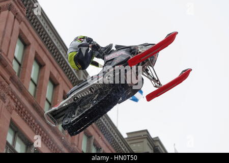 World snowmobiling champions perform aerial tricks in downtown Montreal. Stock Photo