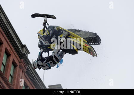 World snowmobiling champions perform aerial tricks in downtown Montreal. Stock Photo
