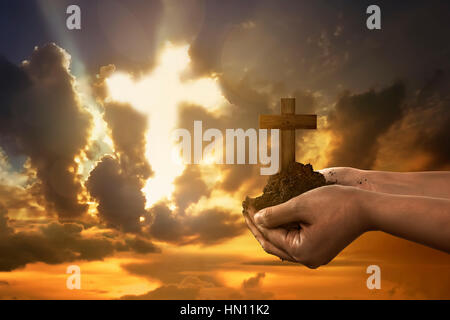 Human hand holding Christian cross with blue sky background Stock Photo ...