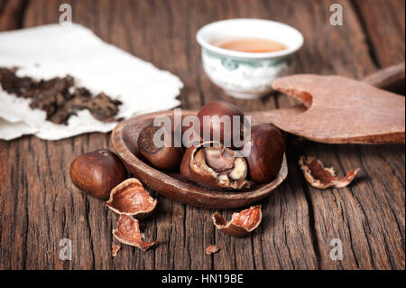 closeup roasted chestnuts on wooden desk Stock Photo