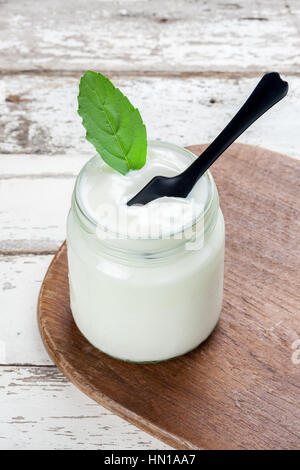 natural yogurt in glass on wooden plank Stock Photo