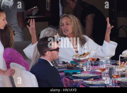 Sharon Stone eats lunch in her bathrobe and no make-up on the Roberto Cavalli yacht in the harbor at the 66th Cannes Film Festival in Cannes, France on May 21, 2013. Photo by Francis Specker Stock Photo