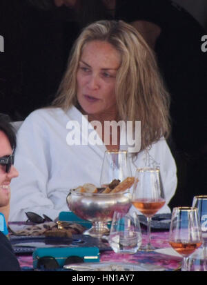 Sharon Stone eats lunch in her bathrobe and no make-up on the Roberto Cavalli yacht in the harbor at the 66th Cannes Film Festival in Cannes, France on May 21, 2013. Photo by Francis Specker Stock Photo