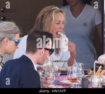 Sharon Stone eats lunch in her bathrobe and no make-up on the Roberto Cavalli yacht in the harbor at the 66th Cannes Film Festival in Cannes, France on May 21, 2013. Photo by Francis Specker Stock Photo