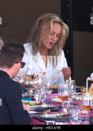 Sharon Stone eats lunch in her bathrobe and no make-up on the Roberto Cavalli yacht in the harbor at the 66th Cannes Film Festival in Cannes, France on May 21, 2013. Photo by Francis Specker Stock Photo