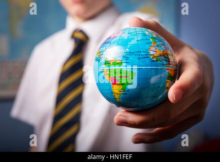 A school boy holding a globe Stock Photo