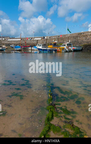 The harbour at Cemaes village on the north coast of Anglesey in Wales, sited on Cemaes Bay, an Area of Outstanding Natural Beauty which is partly owne Stock Photo