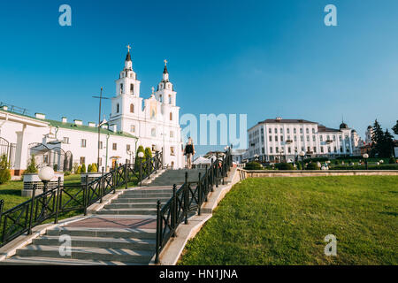 Minsk, Belarus. Young Woman On Top Of Stairway Leading To Holy Spirit Cathedral, Main Temple Of Belarusian Orthodox Church. White Baroque Building, Fa Stock Photo