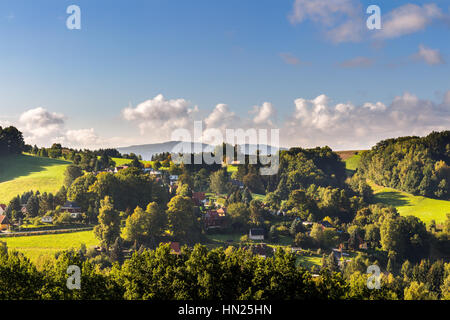 Saxon Switzerland (Bohemian Switzerland or Ceske Svycarsko) meadow and village on a sunny day in summer Stock Photo