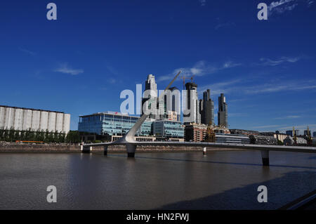 Puente de la mujer, with modern high-rise waterfront buildings in the background on beautiful day with clear blue skies in Puerto Madero, Buenos Aires Stock Photo
