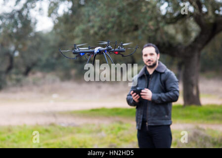 A man Operating The Drone By Remote Control In The Park Stock Photo