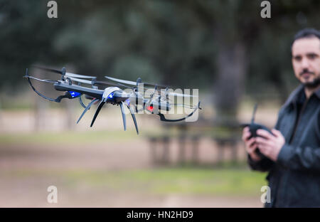 A man Operating The Drone By Remote Control In The Park Stock Photo