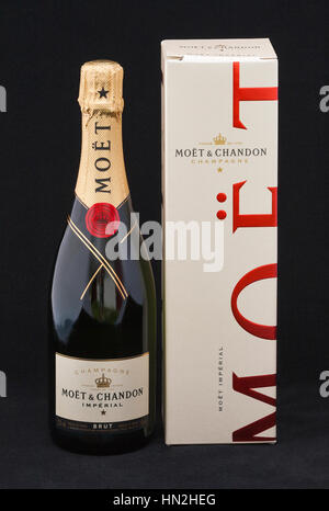 KIEV, UKRAINE - MAY 06, 2012: Moet & Chandon imperial Brut Champagne bottle and box against black. It is one of the world's largest champagne producer Stock Photo